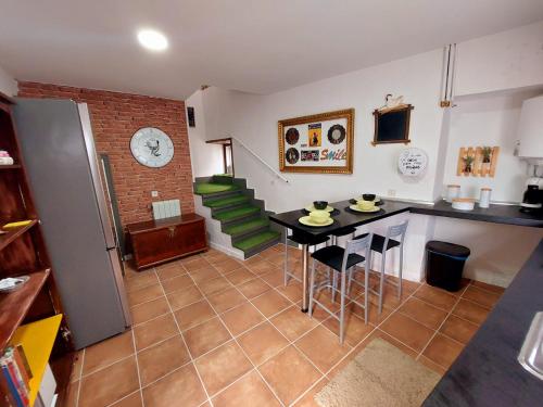 a kitchen with a counter and a table in a room at Casa Mencía in Camponaraya
