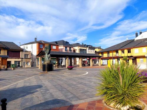 an empty street in a town with buildings at Casa Mencía in Camponaraya