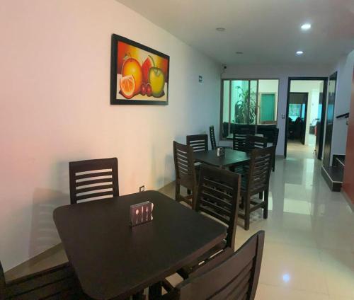 una sala da pranzo con tavoli e sedie e un dipinto sul muro di ALO INN Hotel a San Roque