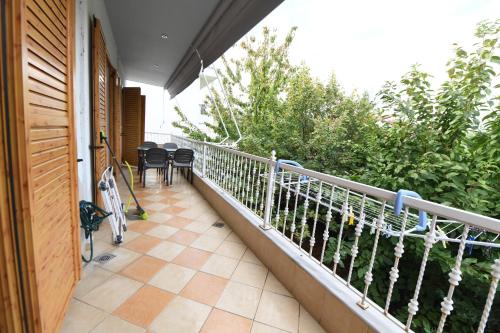 a balcony with chairs and a bike parked on it at NIKITA'S HOUSE -4 bedrooms 5' from racetrack in Serres
