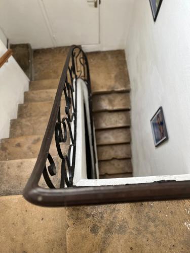 a staircase with a metal railing in a building at Bayeux in Bayeux