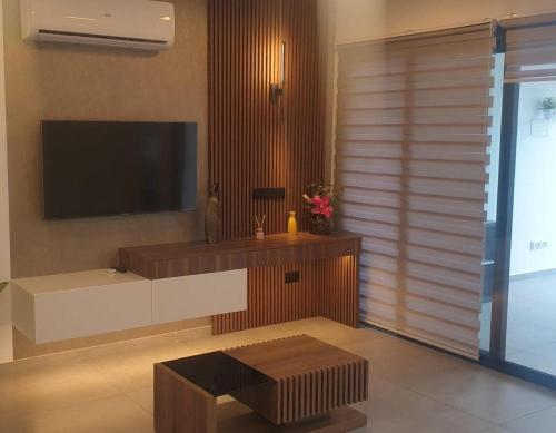 a living room with a tv on the wall at Deluxe 1 Bed Apt Ayios Dometios in Ayios Dhometios