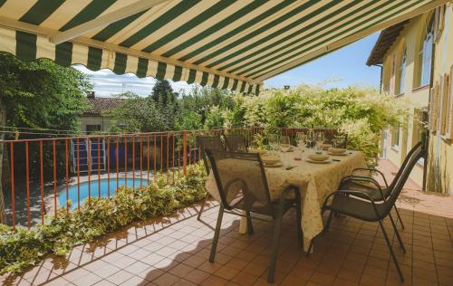 a patio with a table and chairs and a pool at Casa del Sole in Castagnole Lanze