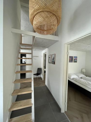 a room with a staircase leading to a bunk bed at Brand New Waterfront-Apartment in Hvalvík