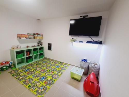 a living room with a flat screen tv on the wall at Cihlářka - Liščí doupě 110 in Pec pod Sněžkou