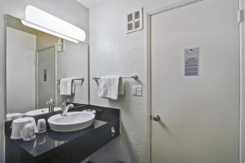 a bathroom with a sink and a mirror at Motel 6 in Colorado Springs