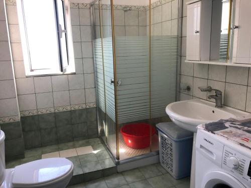 a bathroom with a shower and a toilet and a sink at Quality home in Sarandë