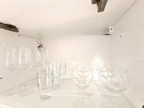 Une bande de verres à vin vides sur un mur dans l'établissement Meublé Flora pour voyageur pro - Centre, calme - Wi-Fi, à Haguenau