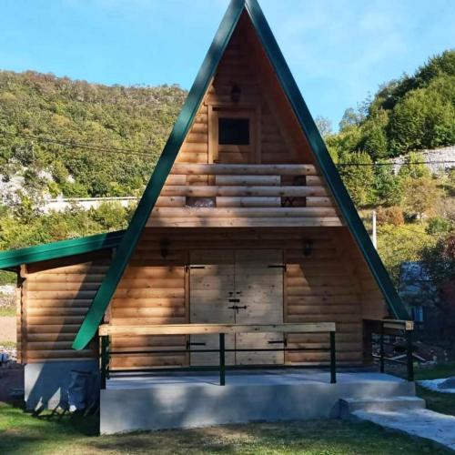 a large log cabin with a pitched roof at Nice cabin in Cetinje