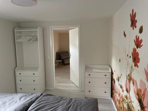 um quarto com uma cama, 2 cómodas e um espelho em Ferienwohnung im Schwedenhaus em Großpostwitz