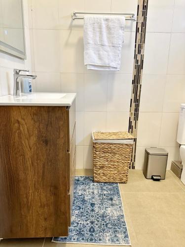 a bathroom with a sink and a shower at Pebble Bay Garden View F3 in Grand-Baie