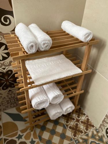 a bamboo towel rack with towels in a bathroom at Downtown Apartment in Craiova