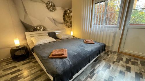 a bedroom with a bed with two towels on it at Lipno Pearl 2 in Lipno nad Vltavou