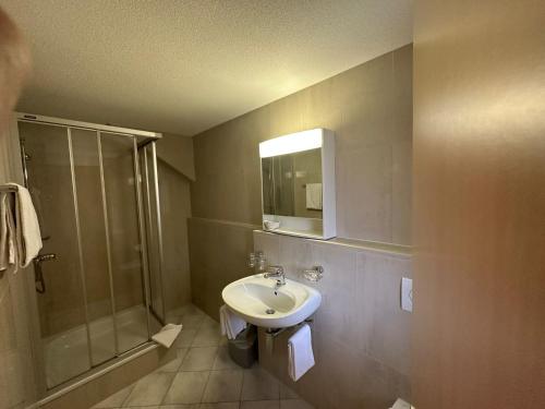 a bathroom with a sink and a shower at Zimmer Mamma Mia in Bürchen