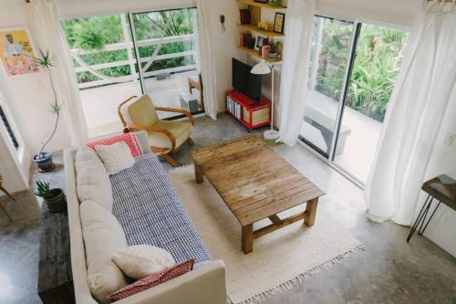 a living room with a couch and a coffee table at Magic Sands Beach Bungalow in Kailua-Kona