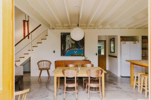 a dining room with a wooden table and chairs at Magic Sands Beach Bungalow in Kailua-Kona