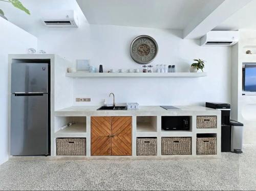 a kitchen with a sink and a refrigerator at Villa Endless - Two Bedroom Family Suite - Beachfront Luxury - Bingin Beach in Uluwatu