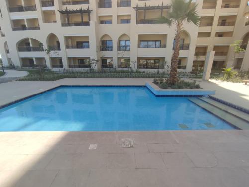 a large swimming pool in front of a building at Lovely studio Al-Dau Heights in Hurghada