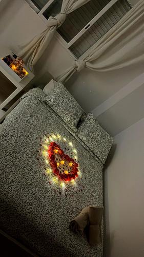 a bedroom with a bed with a chandelier on it at Castle Apartment in Alicante