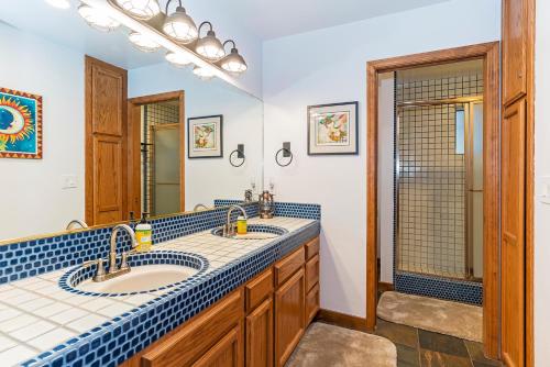 a bathroom with two sinks and a shower at 451 First Green Dr - Mountain Home in Incline Village