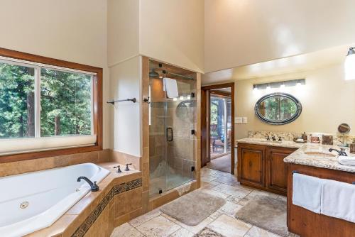 uma casa de banho com uma banheira, um chuveiro e um lavatório. em 585 Knotty Pine - Gorgoeous Moutain Home em Incline Village