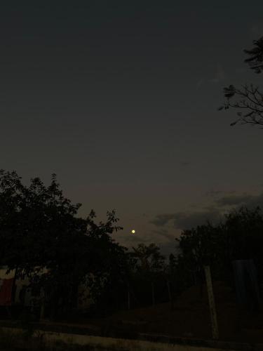 a cloudy sky with the moon in the distance at Sítio morada nova in Contagem