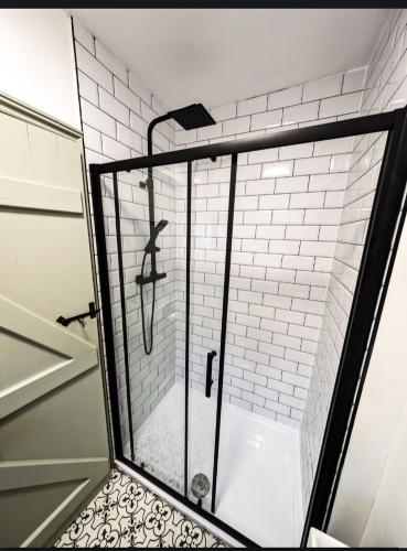 a shower with a glass enclosure in a bathroom at The White Hart in King's Lynn