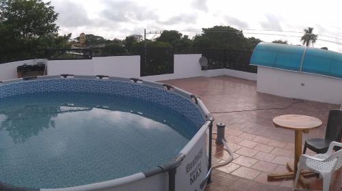 a large swimming pool on a patio with a table at La Reserva de UBA in El Socorro