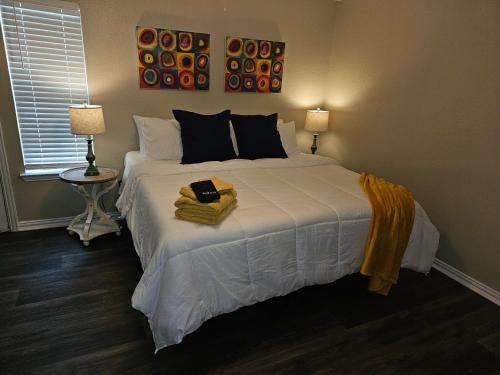 a bedroom with a large white bed with two lamps at KING BED! Walk To AT&T Stadium, Globe Life in Arlington
