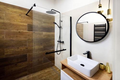 a bathroom with a sink and a mirror at Bonton Apartments in Kežmarok