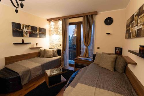 a bedroom with two beds and a window at Apartman W Residence in Kopaonik
