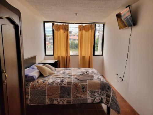 a bedroom with a bed and a large window at Casa Amoblada y Equipada, Completamente Privada in Ibarra