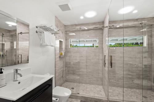 a bathroom with a shower and a toilet and a sink at The Yellow Retreat in Palm Springs