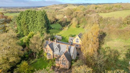 an aerial view of a large house in a field at Country House with 7 bedrooms and 3 buildings in Market Rasen
