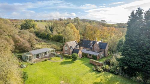 an aerial view of a large house on a grass field at Country House with 7 bedrooms and 3 buildings in Market Rasen