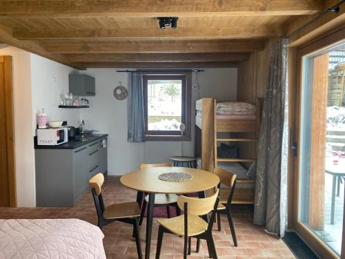 a room with a table and chairs and a bedroom at Harrachov 702 in Harrachov