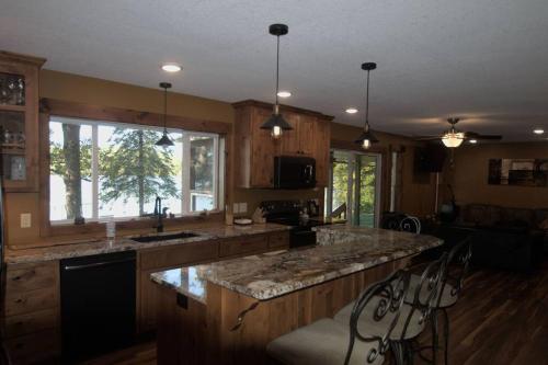 a kitchen with a large island with a counter top at Cuyuna Lake Cabin Retreat in Ironton