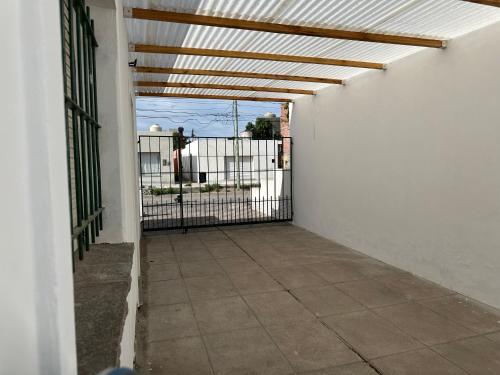 an empty hallway with a gate and a fence at La casa de Chola in Playa Unión