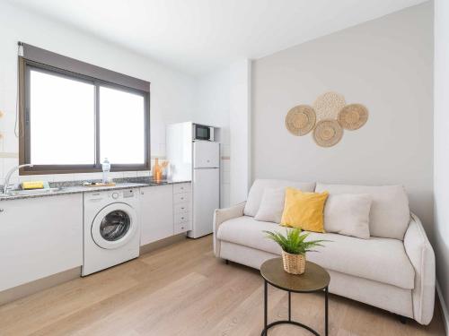 a living room with a couch and a washing machine at Mahostly Apartamento Comillas SE in Arrecife