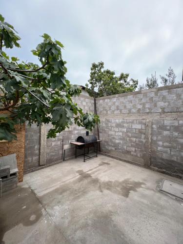 a patio with a brick wall and a bench at Casa centro de Caldera in Caldera