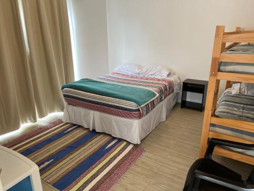 a small bedroom with a bed and a ladder at Casa centro de Caldera in Caldera