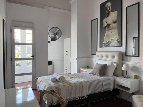 a bedroom with a bed with a statue on the wall at La Casa de Lola BA in Buenos Aires