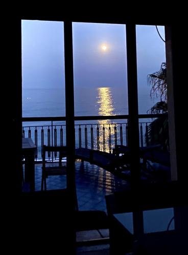 a view of the ocean from a house window at Dimora di Toosa - Near Taormina in Riposto