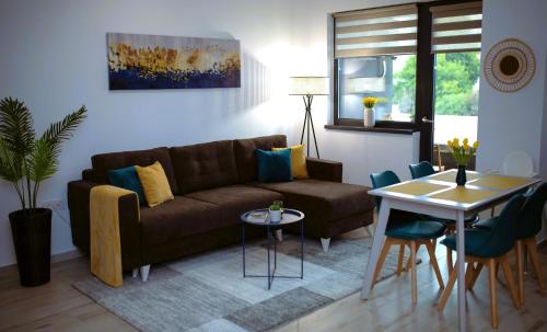 ein Wohnzimmer mit einem Sofa und einem Tisch in der Unterkunft 'Just like home' Apartment - with Private Parking Place in Galaţi