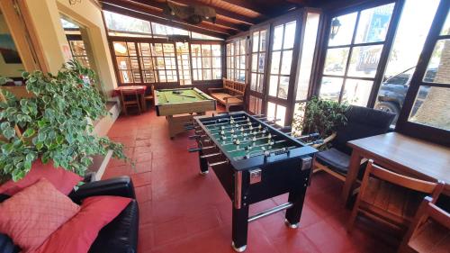 a room with a foosball table and pool tables at Hotel Viola in La Paloma