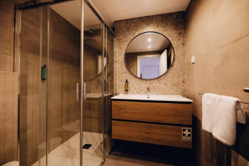 a bathroom with a sink and a mirror at Casas do Calhau Miúdo - Seixal in Seixal