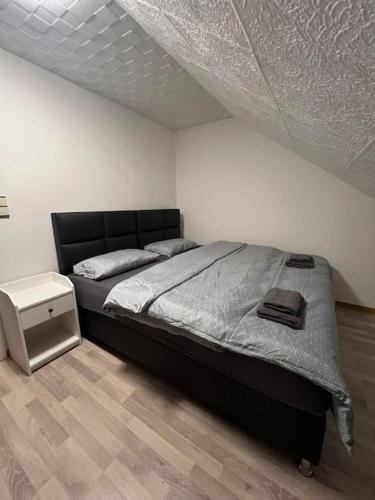a bedroom with a large bed and a white wall at Wohnung in Herford in Herford