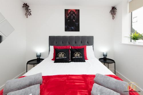 a bedroom with a bed with a red blanket at Hades Apartment - The Soul of Town in Southampton