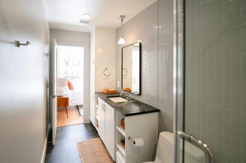 a bathroom with a sink and a mirror at Western 1924 Luxury Lofts in Martindale