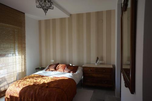 a bedroom with a bed and a dresser and a window at Cute and relaxing bed and breakfast en Albayzín in Granada